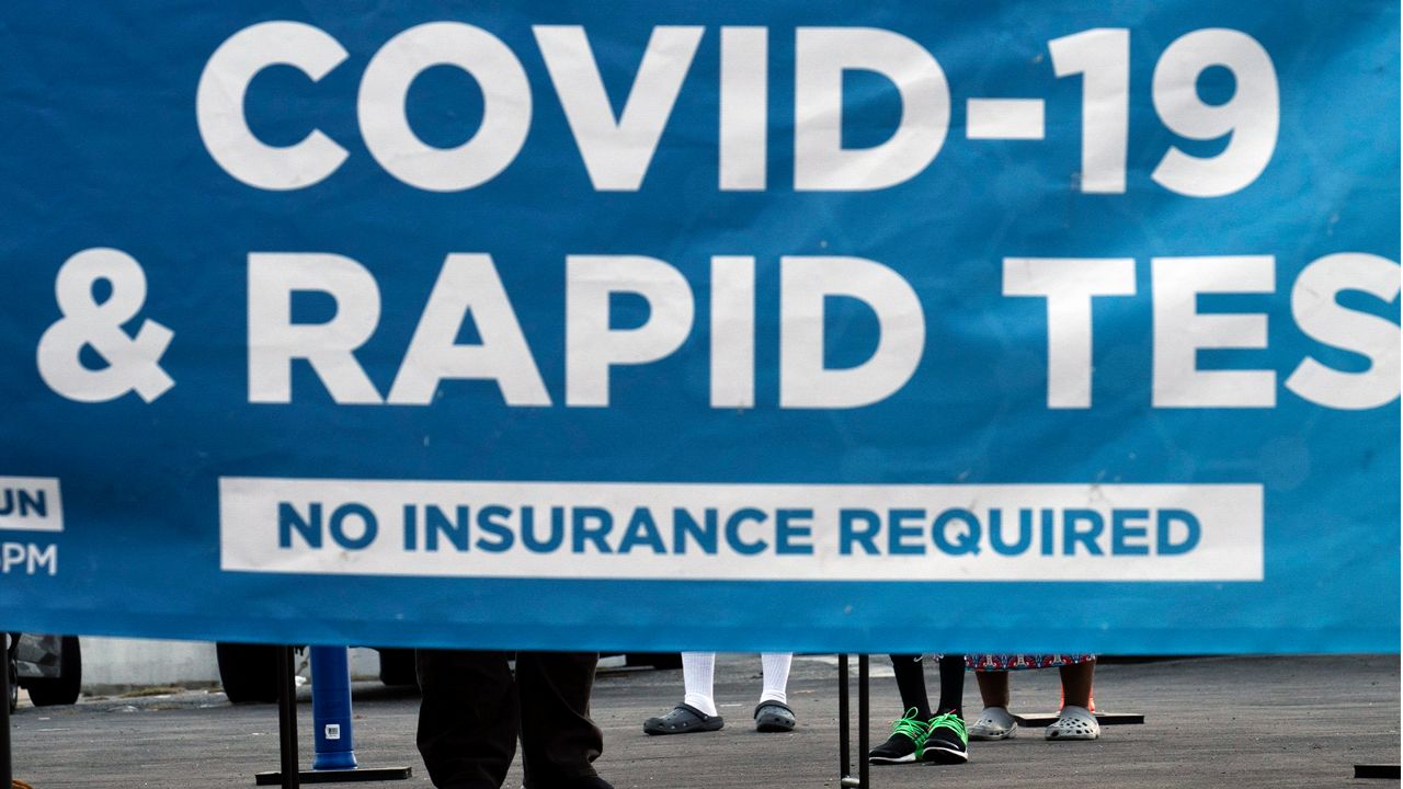 People wait to get tested for COVID-19 at a pop-up testing site in Los Angeles, Monday, Dec. 20, 2021. (AP Photo/Jae C. Hong)