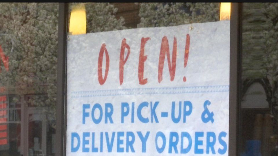 An "Open! For Pick-Up & Delivery Orders" sign in a restaurant window (Spectrum News/File)