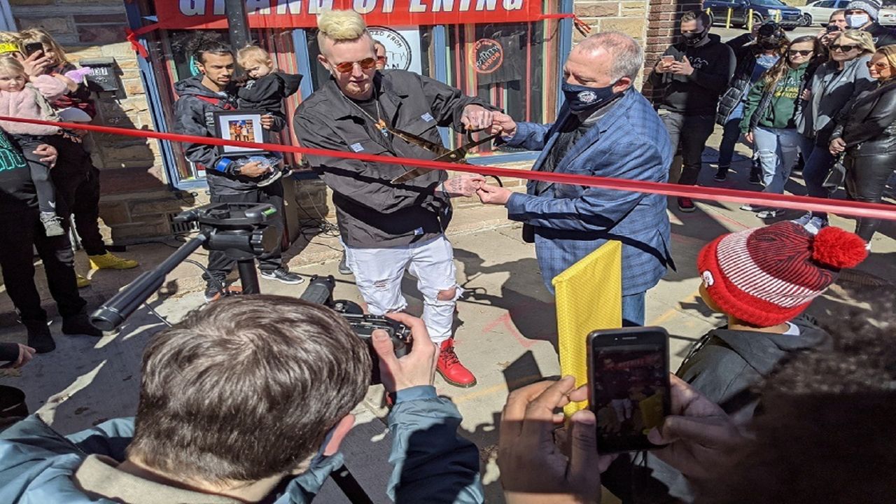 Owner Kenny Lambert (left) and Mayor Dan Horrigan cut the ribbon on Just a Dad from Akron store in March 2021. (Courtesy of Just a Dad from Akron)