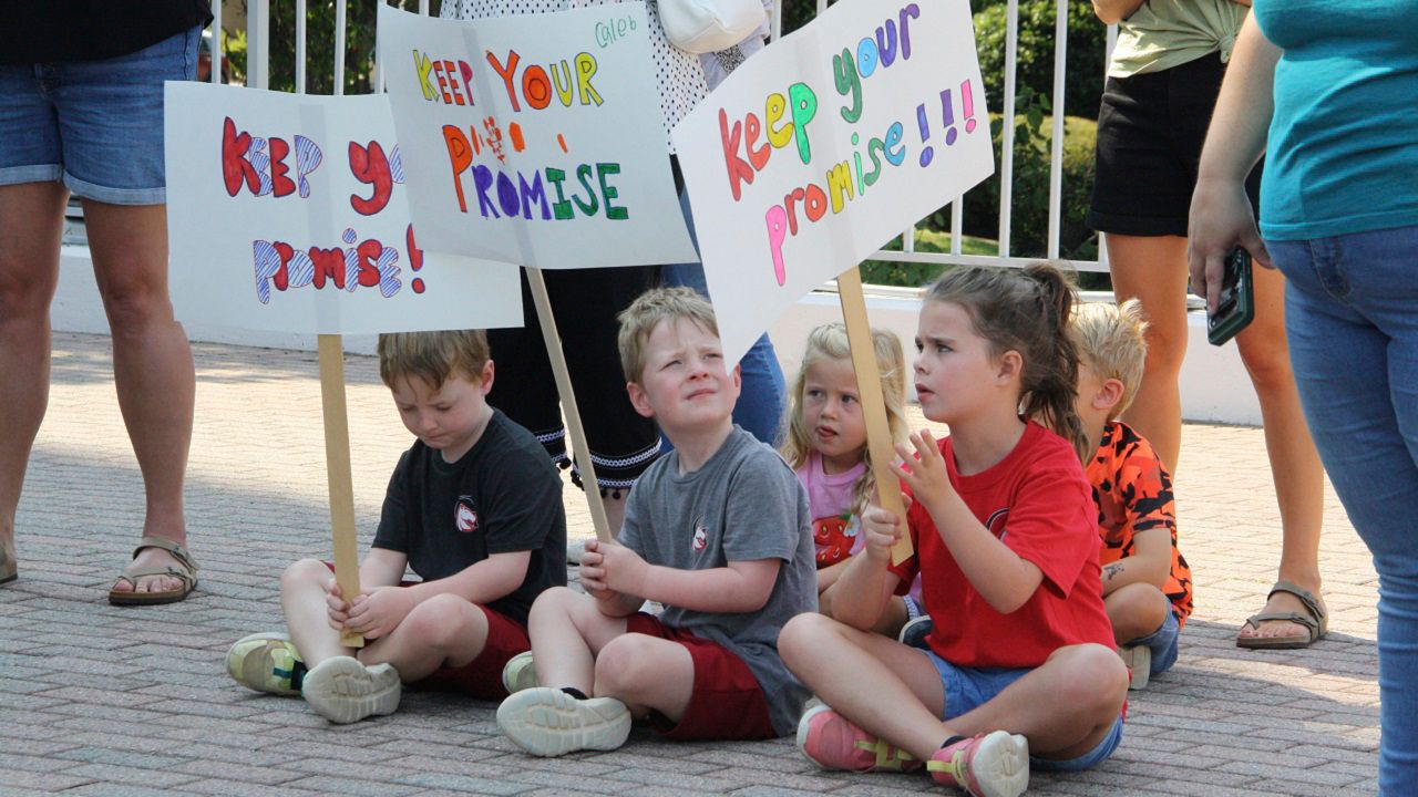 Children hold signs that say Keep Your Promise at the rally for private school scholarships at Halifax Mall in Raleigh, N.C., on July 31, 2024. (AP File Photo/Makiya Seminera)