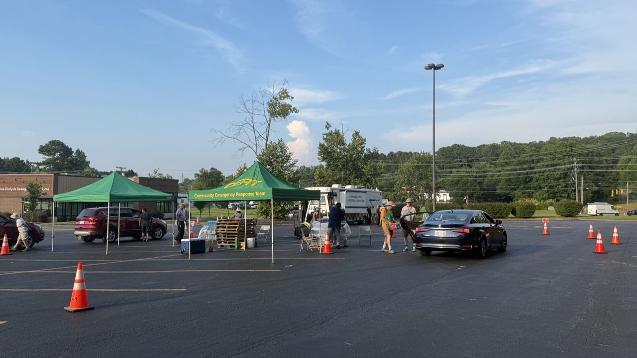 Orange County sets up cases of water distribution site in the parking lot of Orange County Social Services Center, to help those without water. (Spectrum News 1/Ashley Van Havere)
