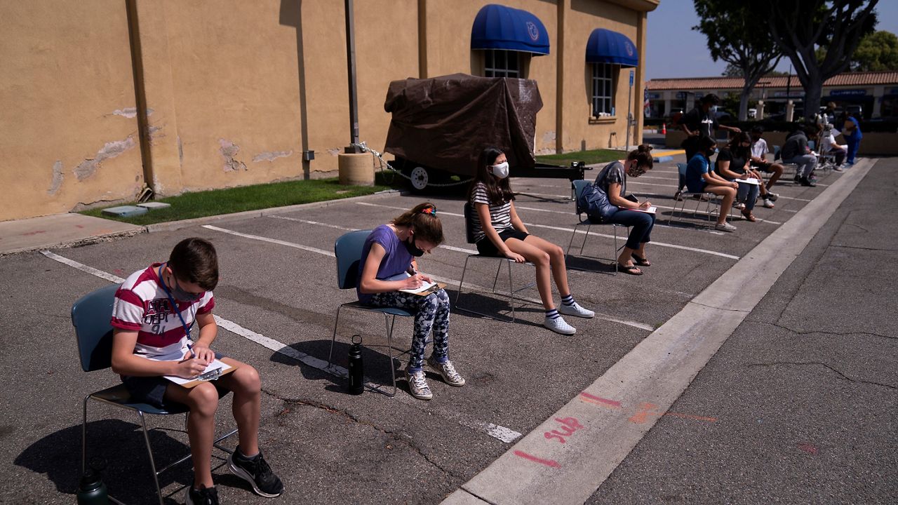 In this May 13, 2021, file photo, children ages 12 to 15 wait to get their vitals checked before getting their Pfizer COVID-19 vaccine at Families Together of Orange County in Tustin, Calif. (AP Photo/Jae C. Hong, File)
