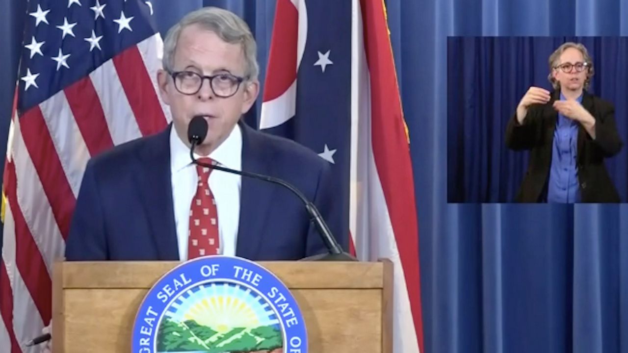 Governor Mike DeWine at a podium speaking