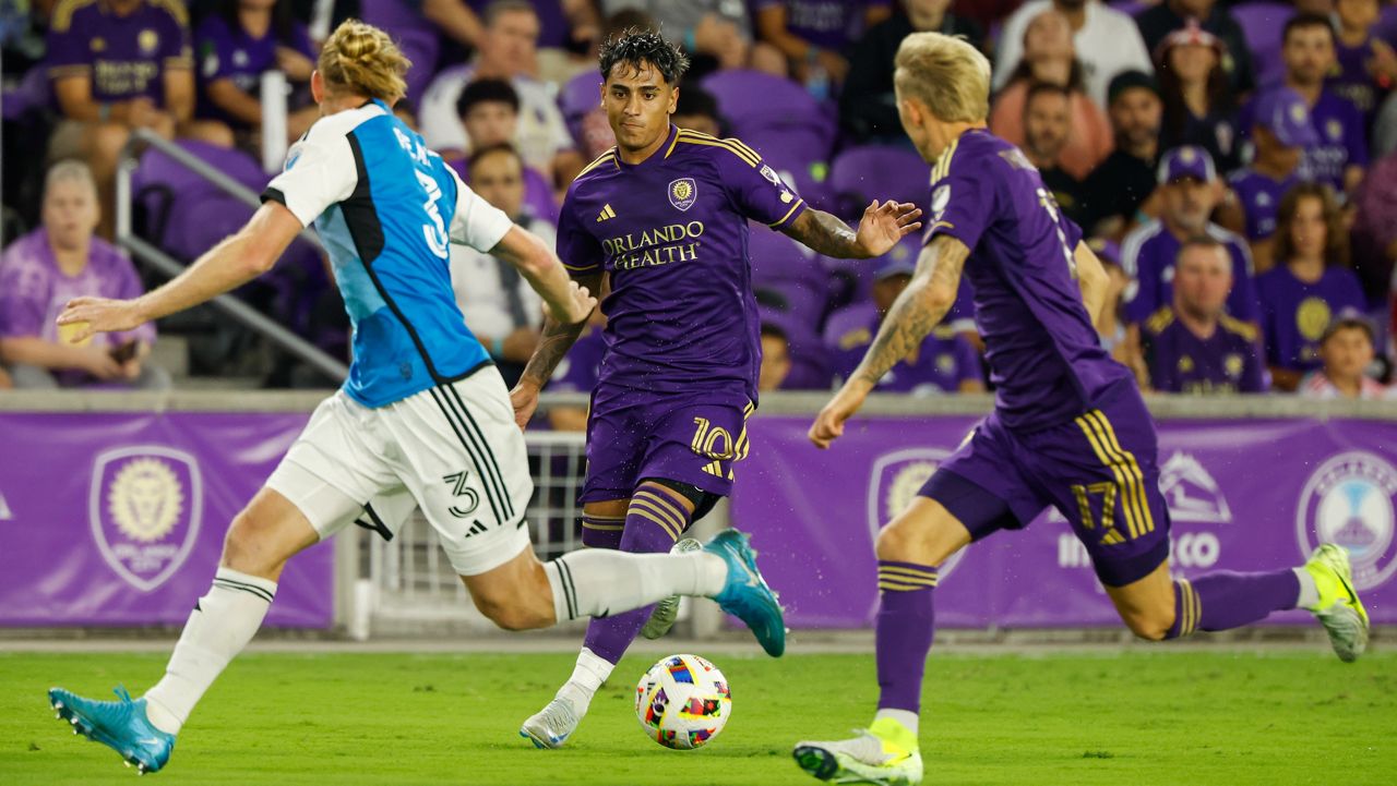 Orlando City forward Facundo Torres (10) brings ball downfield with midfielder Dagur Dan Þórhallsson (17) as he is defended by Charlotte FC's Tim Ream (3) during the first half of a best-of-three first-round soccer match for the MLS Cup, Sunday, Oct. 27, 2024, in Orlando, Fla. (AP Photo/Kevin Kolczynski)