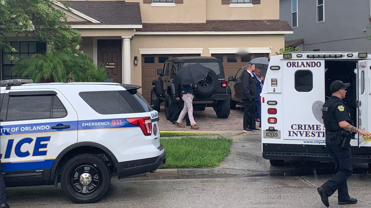 Officers respond to a home on Lake District Lane Tuesday after five people were found dead inside the residence, victims of an apparent murder-suicide, officials say. (Spectrum News 13/Asher Wildman)