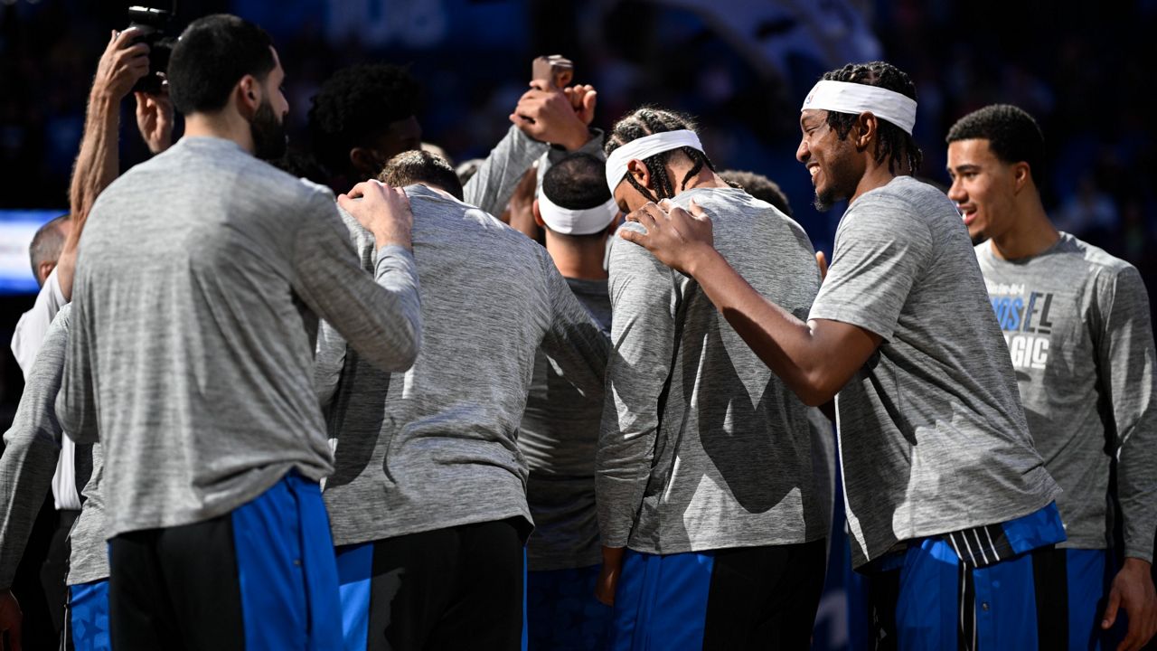 Orlando Magic players huddle on the court before an NBA basketball game against the Detroit Pistons, Sunday, March 3, 2024, in Orlando, Fla. (AP Photo/Phelan M. Ebenhack)