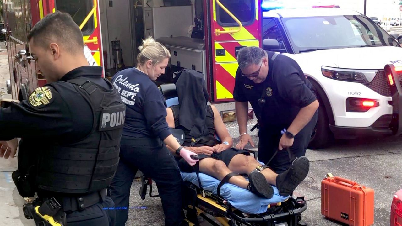 Paramedics attend to an Orlando police officer who was injured Wednesday morning after being dragged by a vehicle allegedly fleeing a traffic stop. (Spectrum News 13)