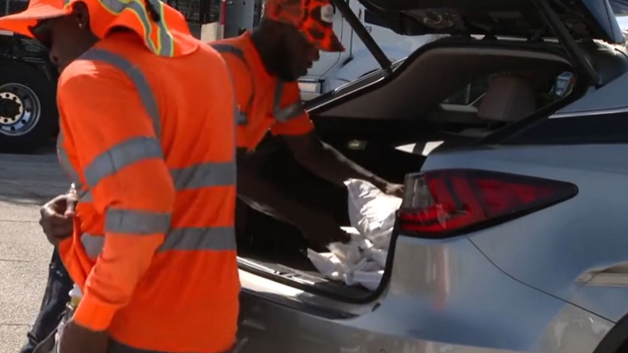Crews with Orlando's Streets and Stormwater Division will load up to 10 free, premade sandbags into residents' vehicles July 10-12. (Spectrum News/Barry Short)