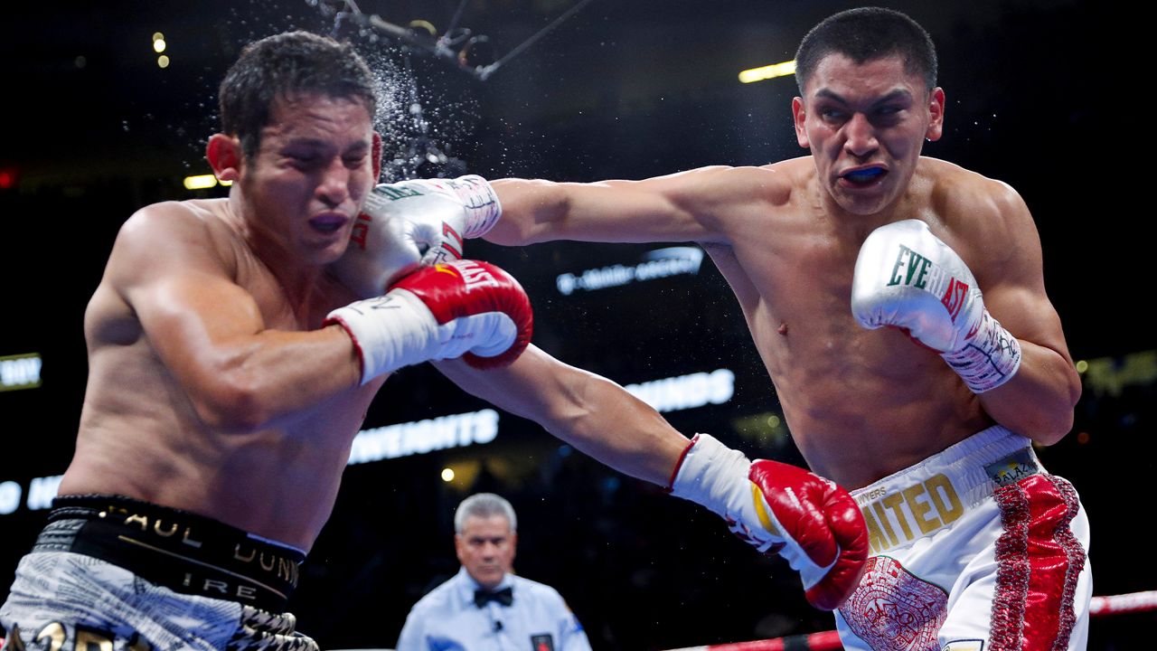 Vergil Ortiz Jr., right, hits Mauricio Herrera during a welterweight boxing match Saturday, May 4, 2019, in Las Vegas. (AP Photo/John Locher)