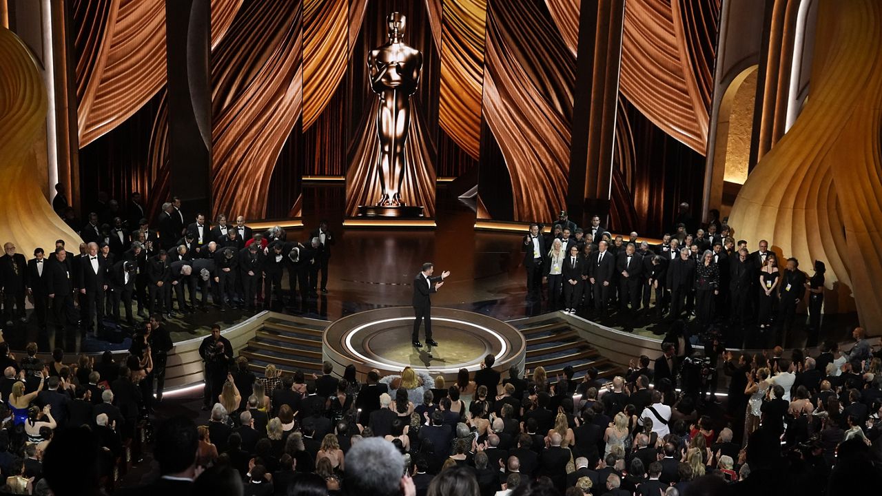 Members of the Oscars crew come out for a round of applause in appreciation for their support during the strike during the Oscars on Sunday, March 10, 2024, at the Dolby Theatre in Los Angeles. (AP Photo/Chris Pizzello)