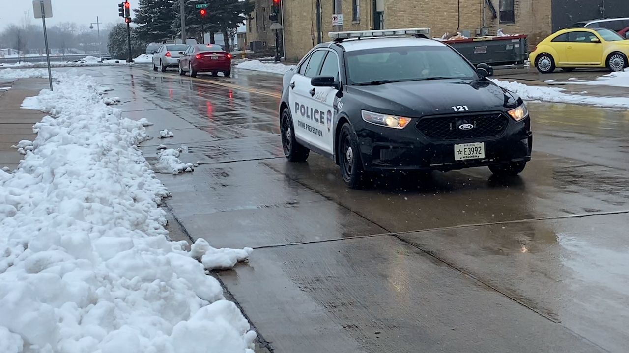 Officer Kate Mann drives a squad car on the streets of Oshkosh, Wisconsin.