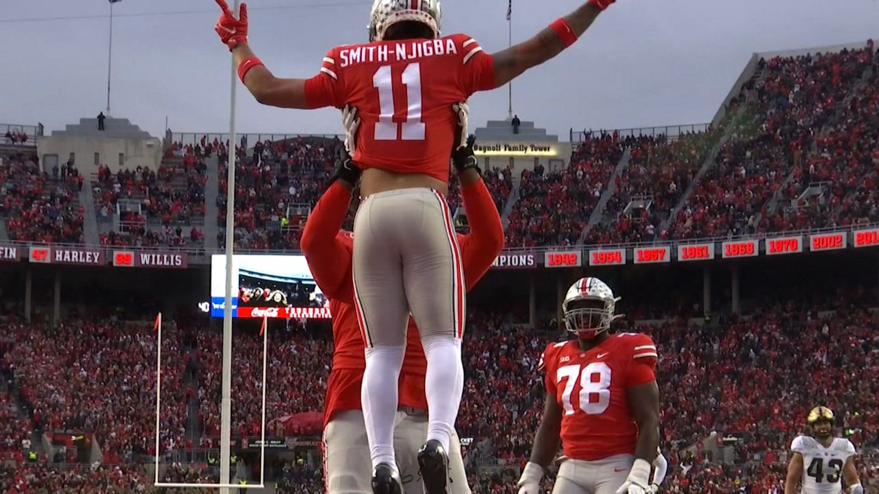 Jackson Smith-Njigba was lifted up by a teammate after scoring against Purdue