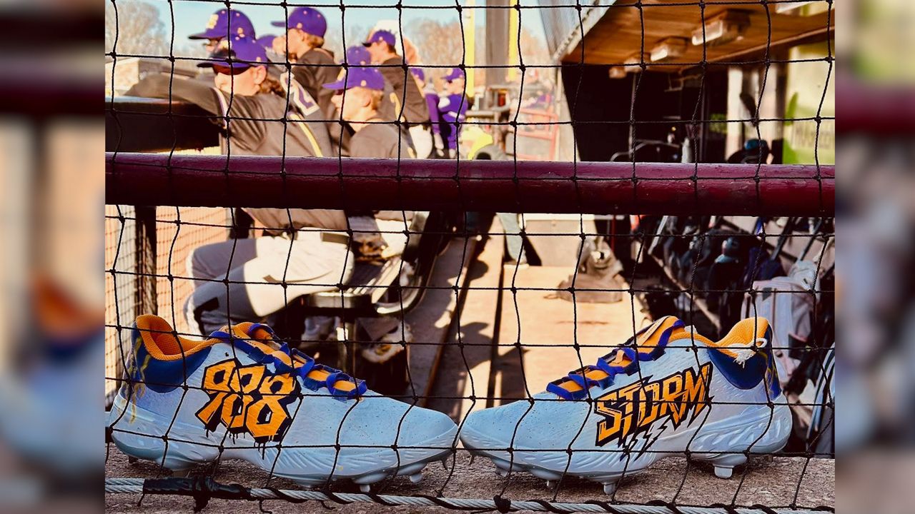 Custom cleats made in honor of Owen Vaughn and his team in the background