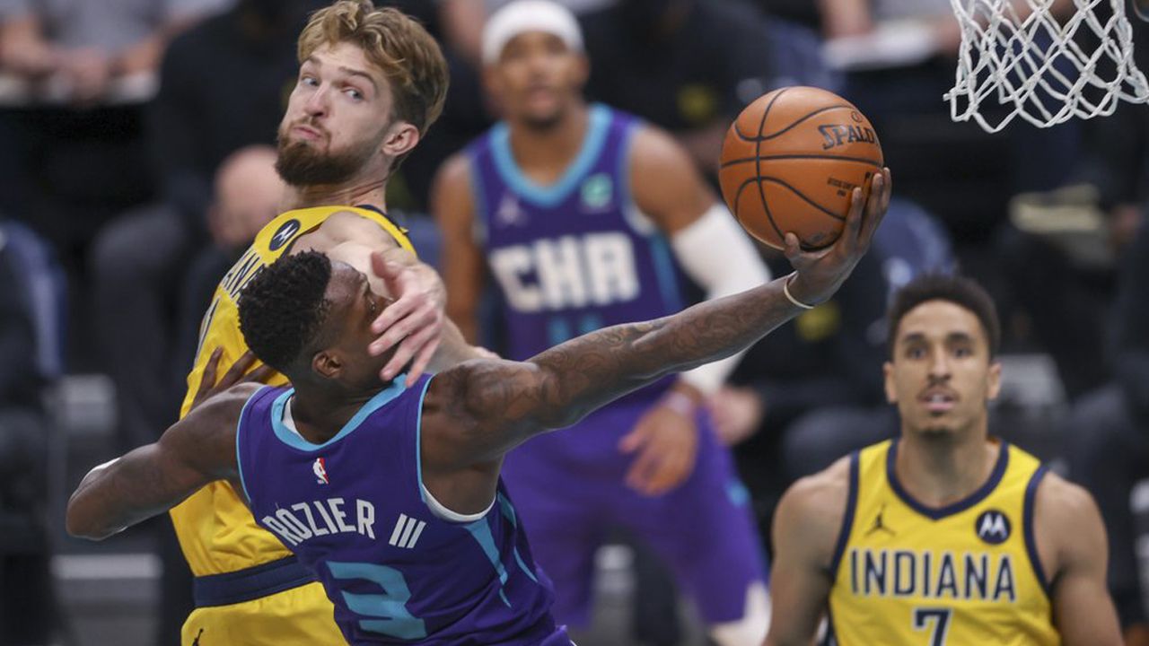 Charlotte Hornets guard Terry Rozier (3) is fouled by Indiana Pacers forward Domantas Sabonis on a drive to the basket during the second half of an NBA basketball game in Charlotte, N.C., Wednesday, Jan. 27, 2021. (AP Photo/Nell Redmond)