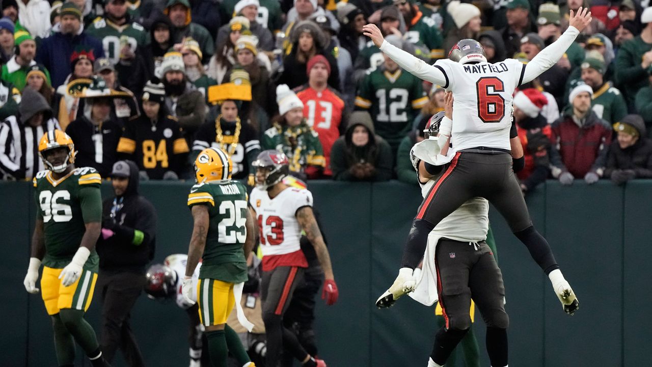 Tampa Bay Buccaneers quarterback Baker Mayfield (6) celebrates with teammate center Robert Hainsey after throwing a 52-yard touchdown pass during the second half of an NFL football game