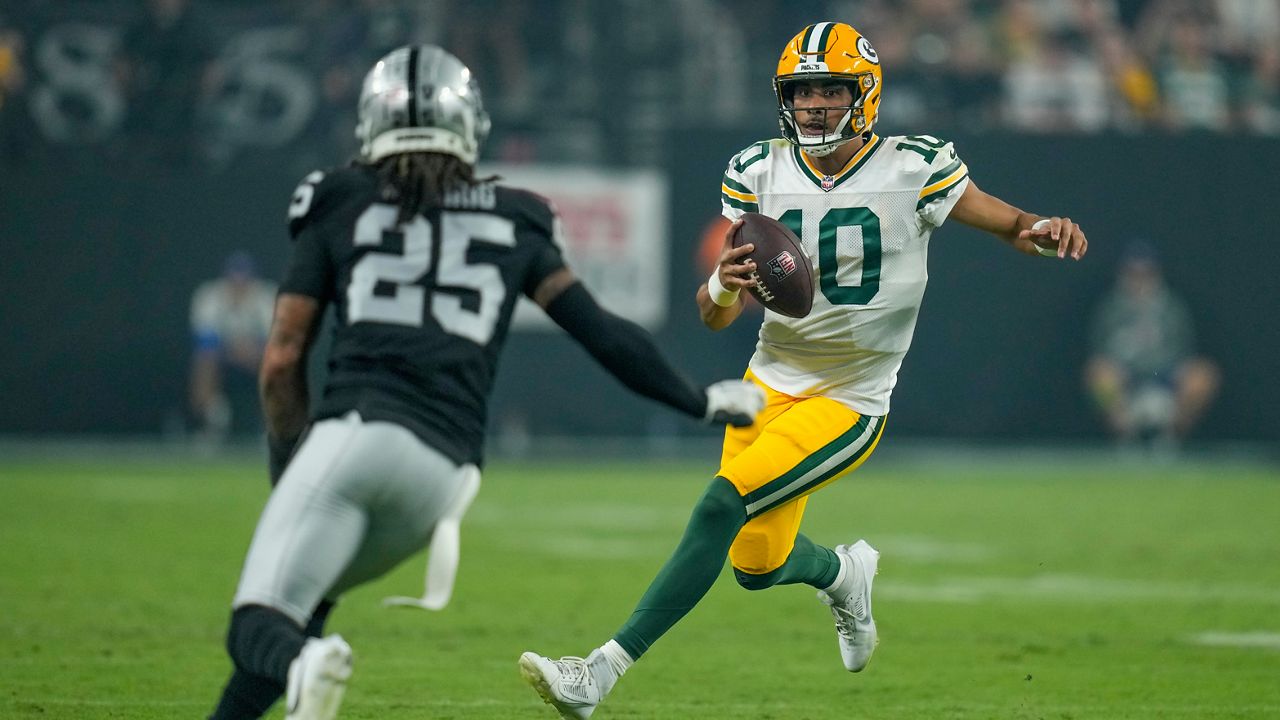 Green Bay Packers' Jordan Love runs against Las Vegas Raiders' Tre'von Moehrig during the second half of an NFL football game