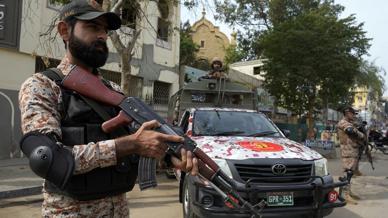 Paramilitary soldiers stand guard on the side of a road for security, ahead of Feb. 8 general elections, in Karachi, Pakistan, Wednesday, Feb. 7, 2024. (AP Photo/Fareed Khan)