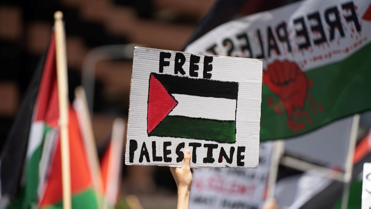 Pro-Palestinian demonstrators hold signs in Los Angeles 