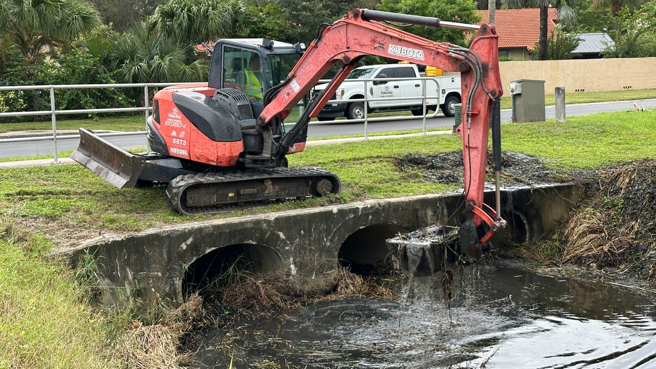 Palm Bay Public Works crews clean a canal on Par Street ahead of Hurricane Helene to prevent overflow. (Spectrum News/Greg Pallone)