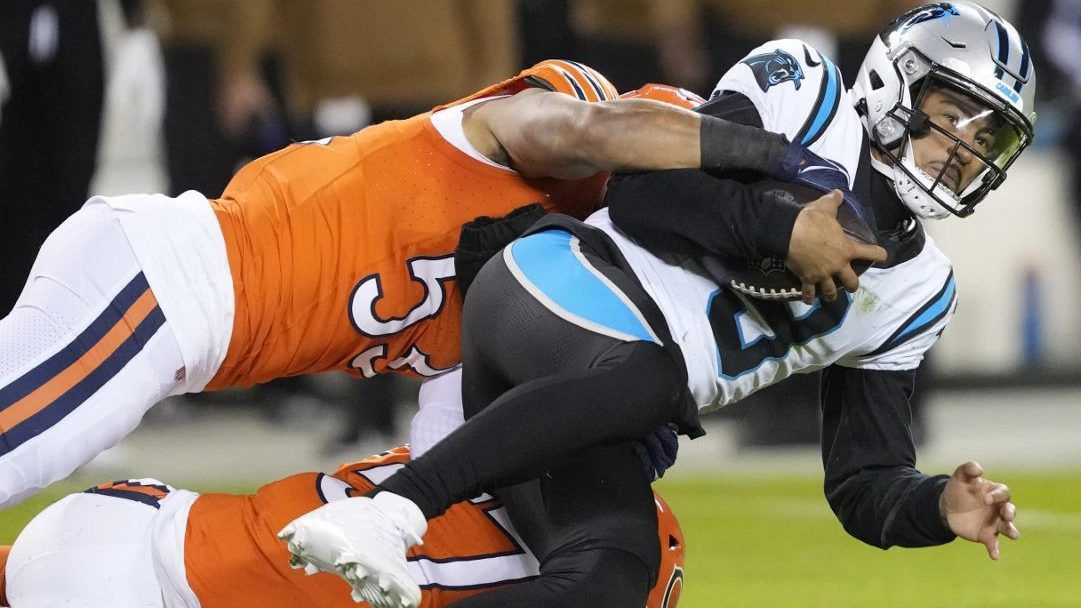 Carolina Panthers quarterback Bryce Young (9) is tackled by Chicago Bears linebacker T.J. Edwards (53) during the first half of an NFL football game Thursday, Nov. 9, 2023, in Chicago. (AP Photo/Charles Rex Arbogast)