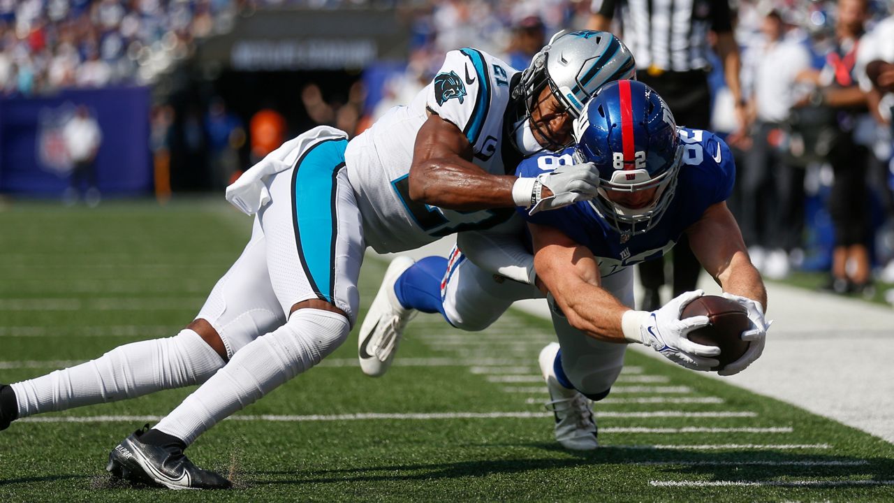 Carolina Panthers' Jeremy Chinn, left, tries unsuccessfully to stop New York Giants' Daniel Bellinger from scoring a touchdown Sunday, Sept. 18, 2022, in East Rutherford, N.J. (AP Photo/John Munson)