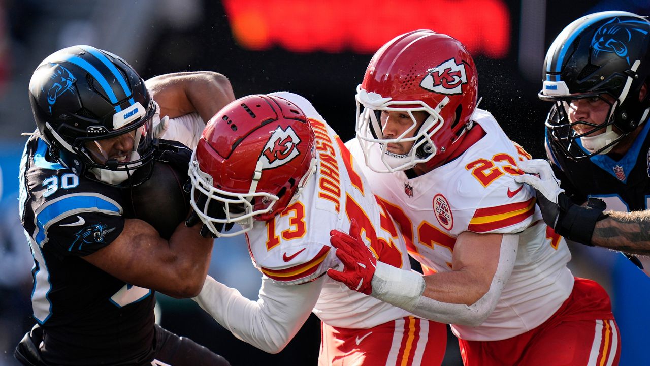 Kansas City Chiefs safety Nazeeh Johnson (13) hits Carolina Panthers running back Chuba Hubbard (30) during the second half of an NFL football game, Sunday, Nov. 24, 2024, in Charlotte, N.C. (AP Photo/Rusty Jones)