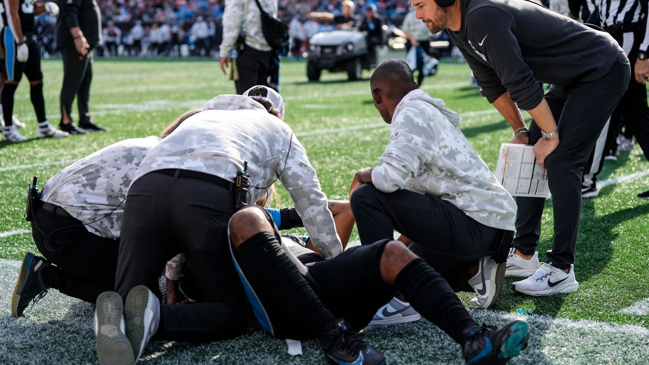 Carolina Panthers tight end Ja'Tavion Sanders (0) is helped by staff after an injury against the Kansas City Chiefs on Sunday, Nov. 24, 2024, in Charlotte, N.C. (AP Photo/Rusty Jones)