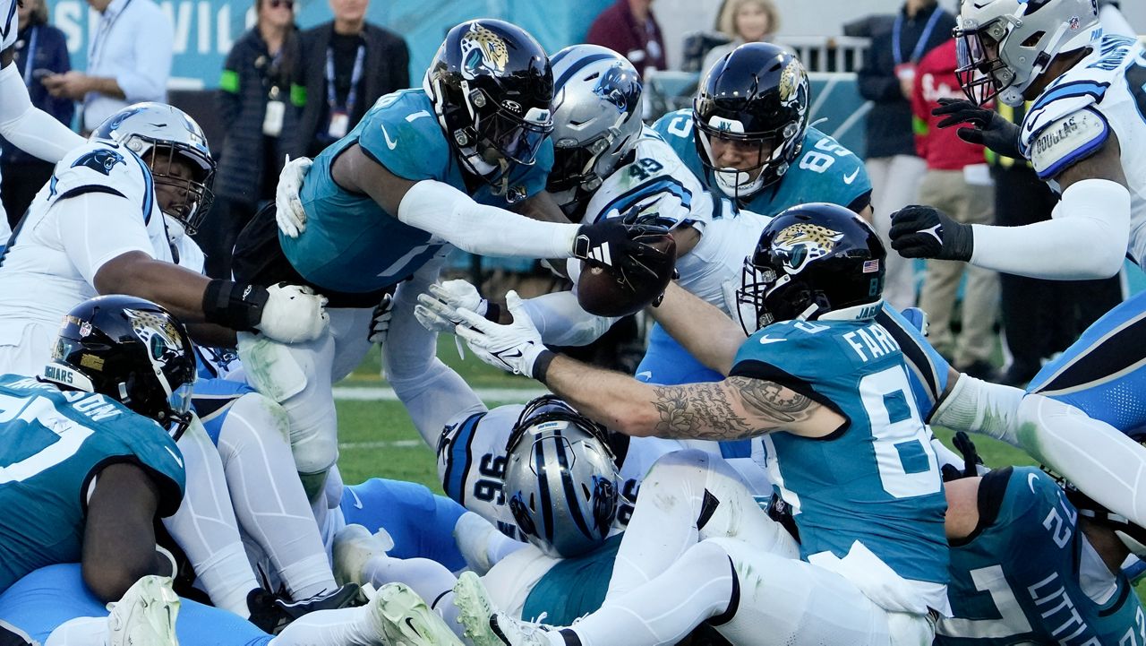 Jacksonville Jaguars running back Travis Etienne Jr. scores against the Carolina Panthers during the second half of an NFL football game Sunday, Dec. 31, 2023, in Jacksonville, Fla. (AP Photo/John Raoux)