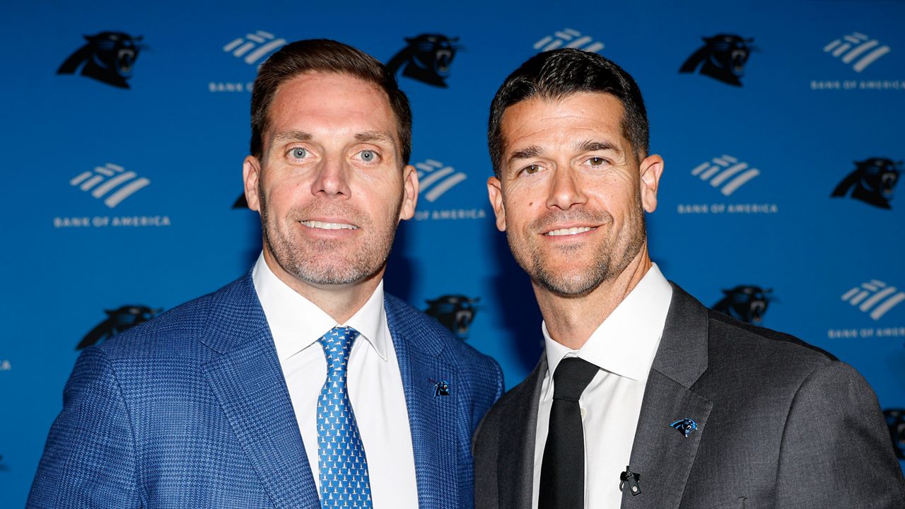 Carolina Panthers president of football operations/general manager Dan Morgan, left, and and head coach Dave Canales pose for photos after a press conference introducing them in Charlotte, N.C., Thursday, Feb. 1, 2024. (AP Photo/Nell Redmond)