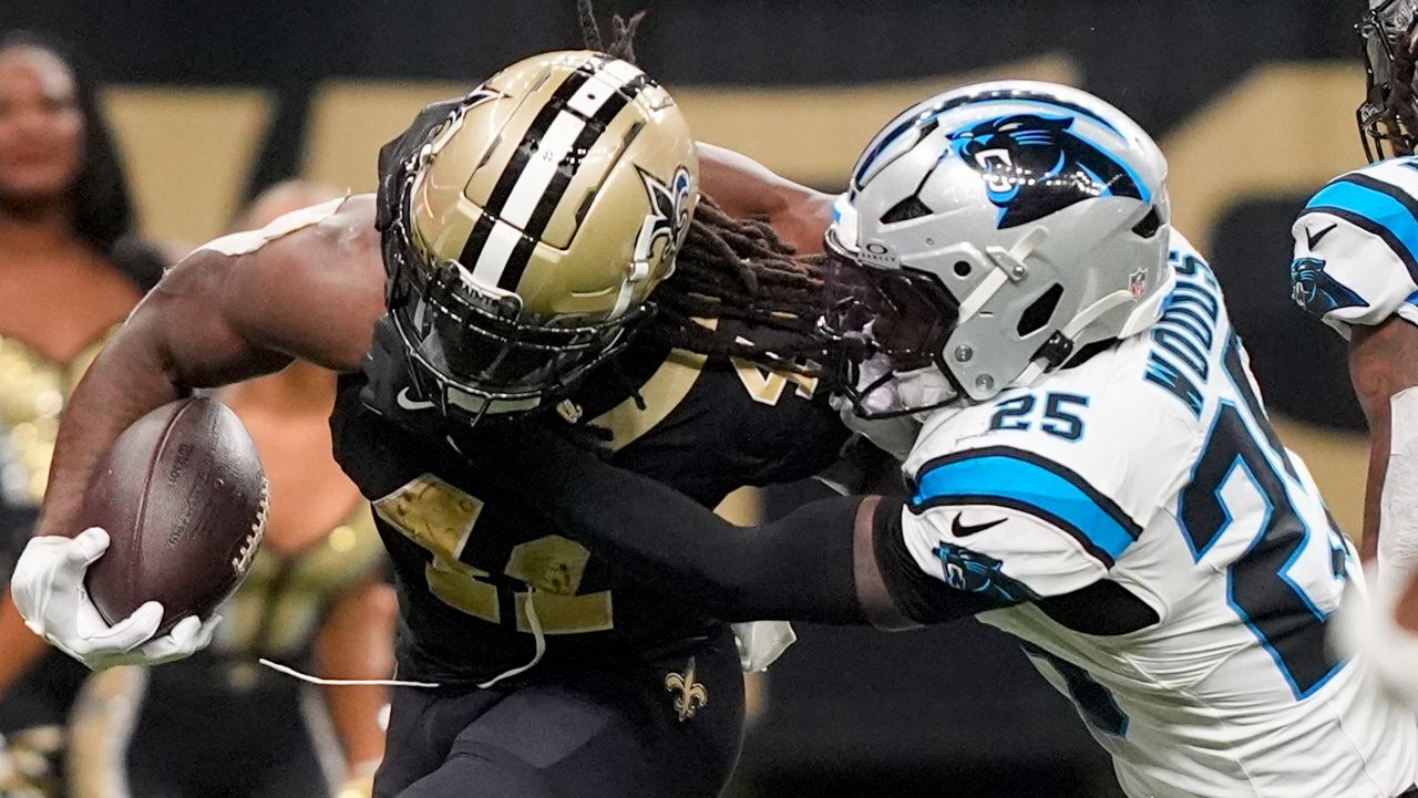 New Orleans Saints running back Alvin Kamara (41) runs the ball against Carolina Panthers safety Xavier Woods (25) during the second half of an NFL football game Sunday, Sept. 8, 2024, in New Orleans. (AP Photo/Gerald Herbert)