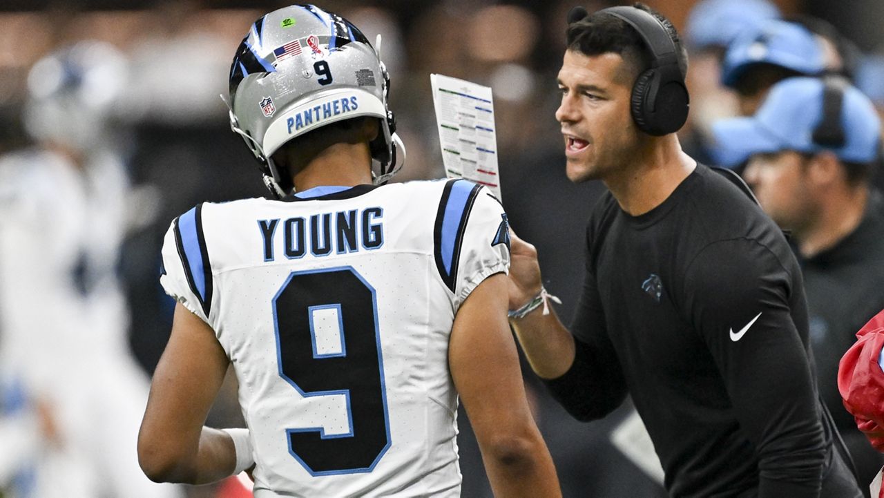 Carolina Panthers head coach Dave Canales right talks to quarterback Bryce Young (9) during the second half of an NFL football game against the New Orleans Saints, Sunday, Sept. 8, 2024, in New Orleans. (AP Photo/Matthew Hinton)