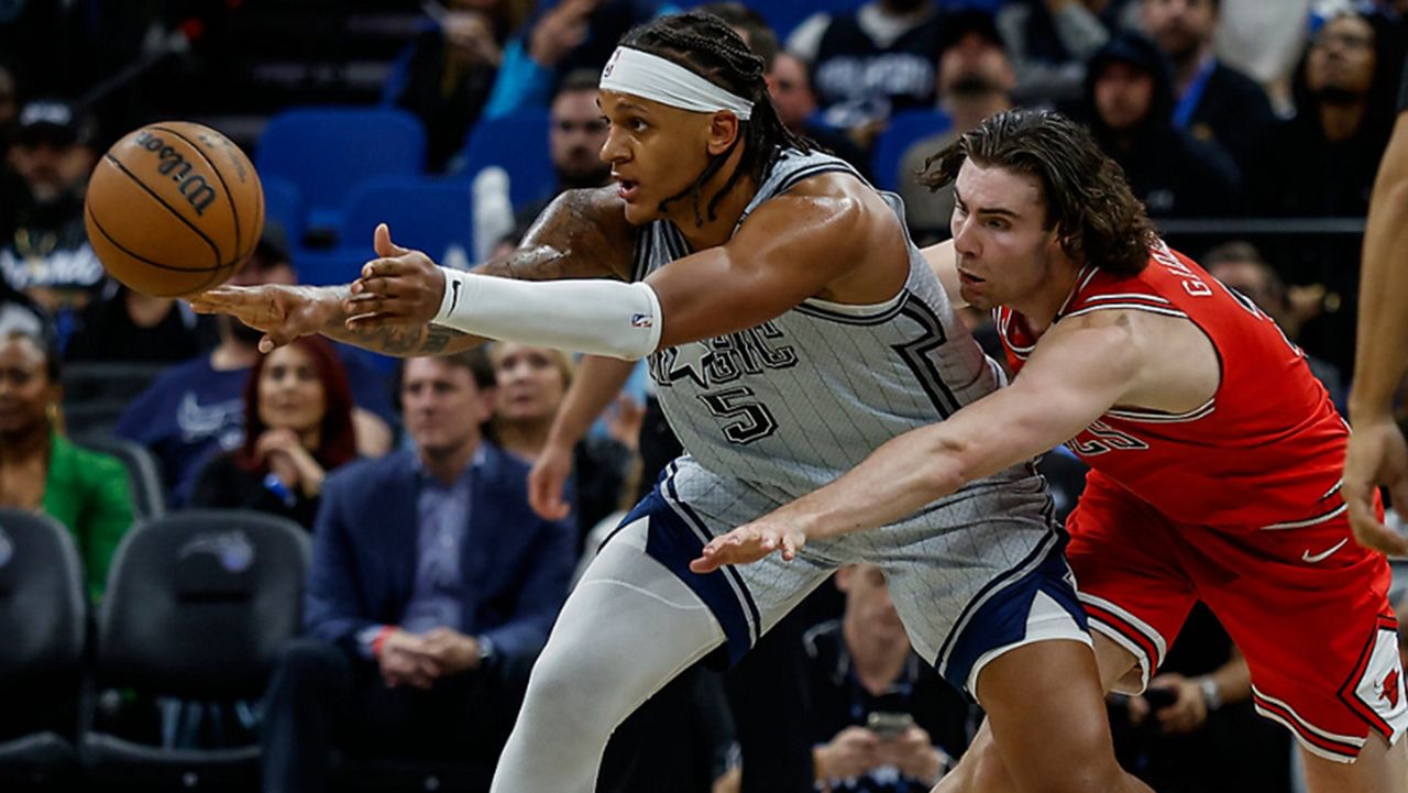 Orlando Magic forward Paolo Banchero (5) is defended by Chicago Bulls guard Josh Giddey, right, during the second half of an NBA basketball game, Thursday, March 6, 2025, in Orlando, Fla. (AP Photo/Kevin Kolczynski)