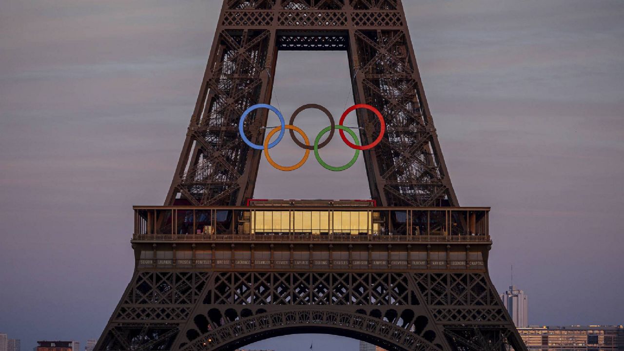 The Olympic rings are mounted on the Eiffel Tower Friday, June 7, 2024 in Paris. The Paris Olympics organizers mounted the rings on the Eiffel Tower on Friday as the French capital marks 50 days until the start of the Summer Games. The 95-foot-long and 43-foot-high structure of five rings, made entirely of recycled French steel, will be displayed on the south side of the 135-year-old historic landmark in central Paris, overlooking the Seine River. (AP Photo/Michel Euler)
