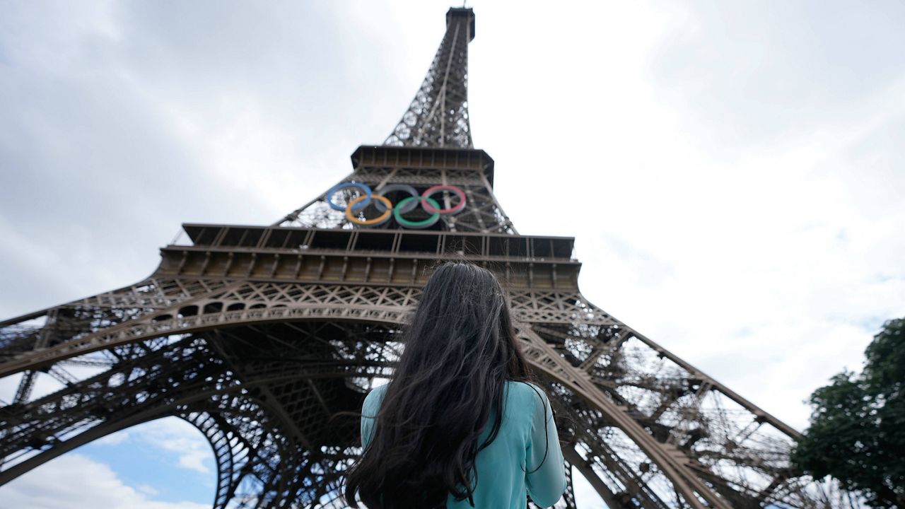 Bangladeshi tourist Rushnia Nur Rayfa stands in front of the Eiffel Tower ahead of the 2024 Summer Olympics, Monday, July 22, 2024, in Paris, France. (AP Photo/Natacha Pisarenko)