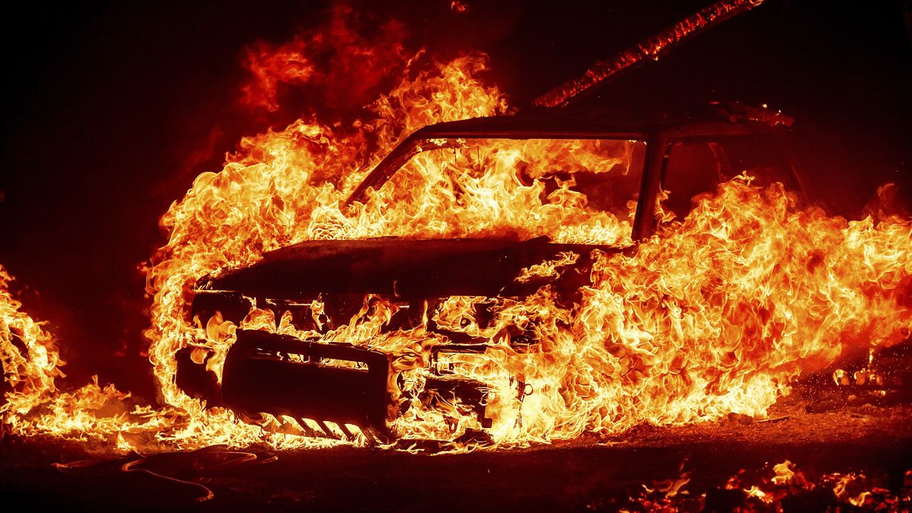 Flames consume a vehicle as the Park Fire burns in Tehama County, Calif., on Friday, July 26, 2024. (AP Photo/Noah Berger)