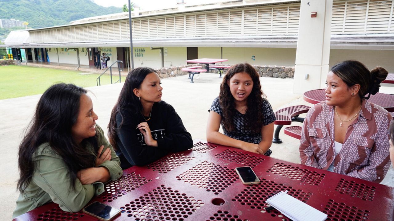 From left, Castle teacher Lauren Pokipala and juniors Keira Torres, Tayli Kahoopii and Hali’a Tom-Jardine advocated for SB1300 and universal free school meals at the Legislature this year. (Honolulu Civil Beat/Kevin Fujii)