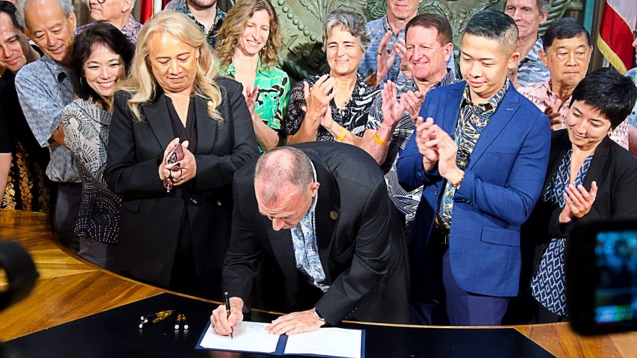 Hawaiʻi State Gov. Josh Green signs the climate change bill. (Honolulu Civil Beat/David Croxford)