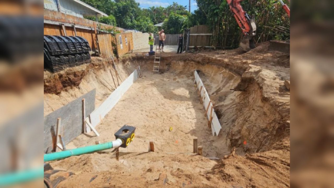 Three sets of iwi kūpuna or ancestral remains were unearthed during the excavation for a new septic system at a residential site in Haleʻiwa. The photo was taken May 2 after the Honolulu Police Department responded to the scene and called staff from the State Historic Preservation Division. (Photo submitted in court filing via Honolulu Civil Beat)