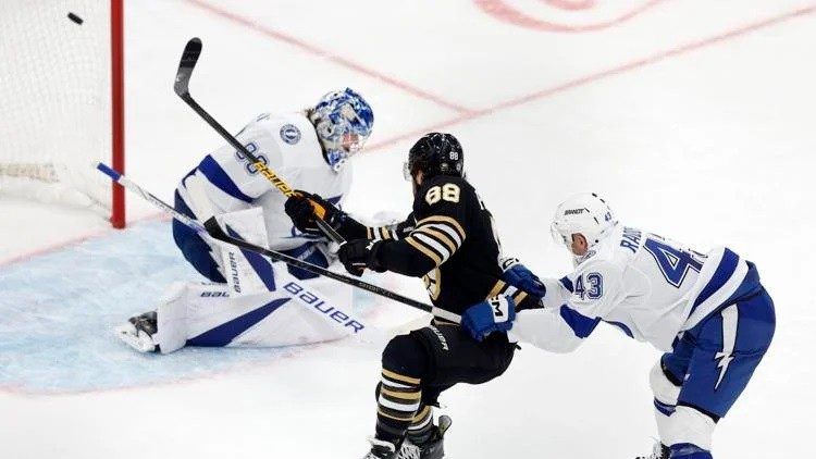 Boston Bruins' David Pastrnak, center, scores on Tampa Bay Lightning's Andrei Vasilevskiy left, as Darren Raddysh (43) defends during the second period of an NHL hockey game, Saturday, Jan. 6, 2024, in Boston. (AP Photo/Michael Dwyer)