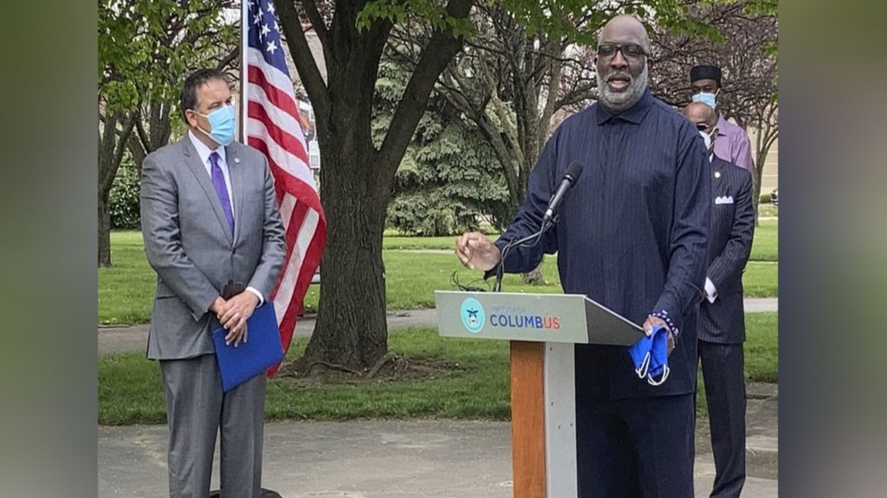 Bishop Timothy Clarke of First Church of God in Columbus, right, calls for peaceful protests during a news conference Monday, April 19, 2021, in Columbus, Ohio. The conclusion of the trial for the officer charged in killing George Floyd in May of 2020 in Minneapolis approaches. Columbus Mayor Andrew Ginther is at left. (AP Photo/Andrew Welsh-Huggins)