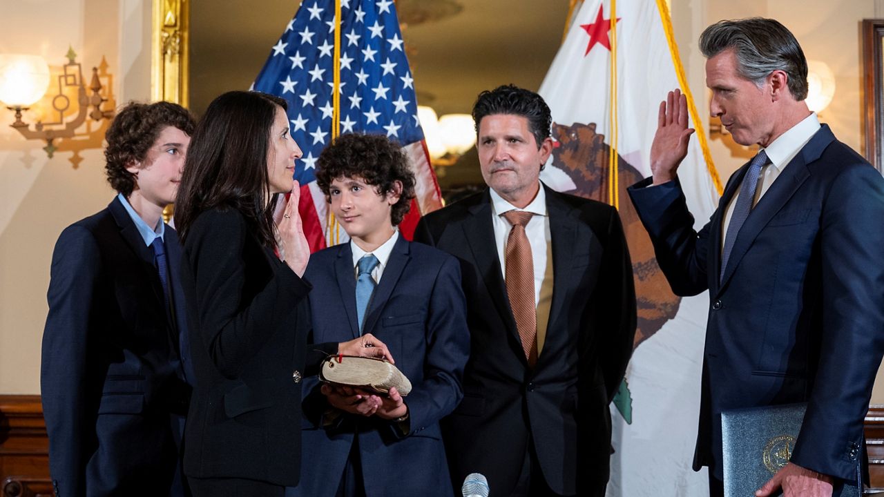 Patricia Guerrero, left, is sworn-in to the California Supreme Court on Monday, March 28, 2022, by Gov. Gavin Newsom at the Stanford Mansion in Sacramento. (Nathaniel Levine/The Sacramento Bee via AP, Pool)
