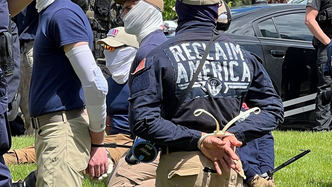 Authorities arrest members of the white supremacist group Patriot Front near an Idaho pride event Saturday, June 11, 2022, after they were found packed into the back of a U-Haul truck with riot gear. (Georji Brown via AP)