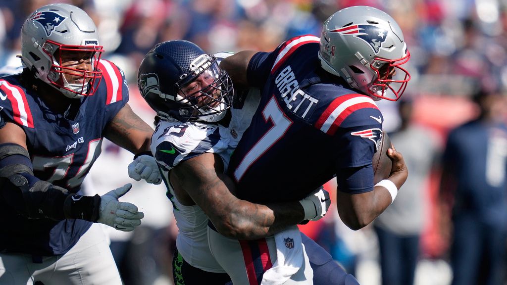 New England Patriots quarterback Jacoby Brissett, right, is sacked by Seattle Seahawks defensive end Leonard Williams, center, in front of Patriots guard Michael Jordan, left, in the second half of an NFL football game, Sunday, Sept. 15, 2024, in Foxborough, Mass. (AP Photo/Charles Krupa)