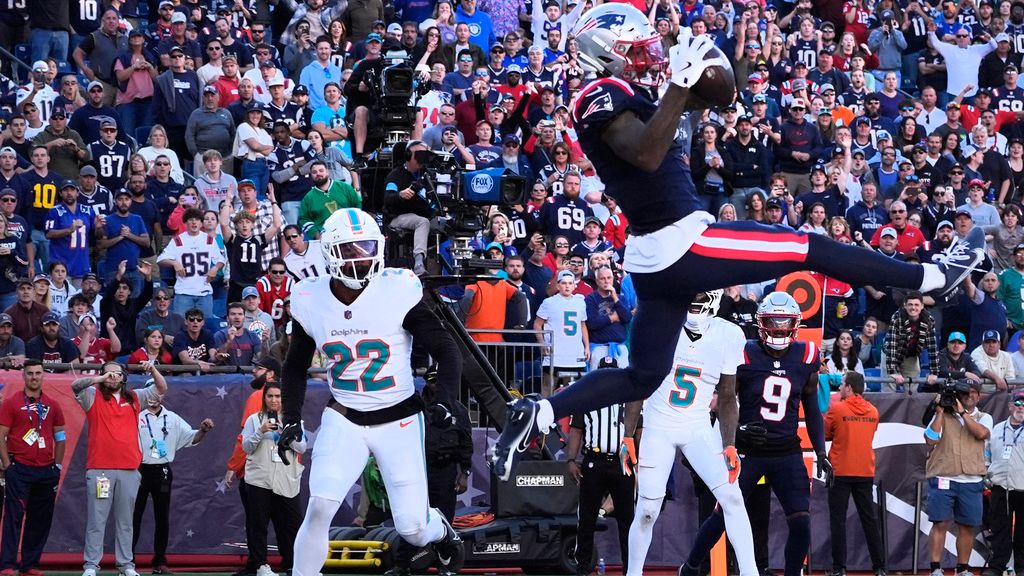 New England Patriots wide receiver Ja'Lynn Polk (1) makes the catch, but later landed out of bounds, as Miami Dolphins safety Elijah Campbell (22) looks on late in the fourth quarter of an NFL football game, Sunday, Oct. 6, 2024, in Foxborough, Mass. (AP Photo/Michael Dwyer)