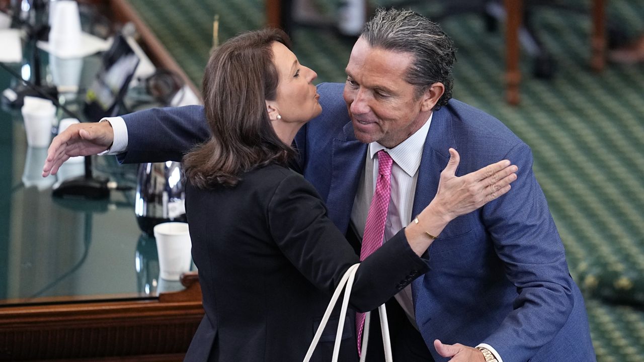 State Sen. Angela Paxton, R-McKinney, wife of suspended Texas state Attorney General Ken Paxton, left, embraces defense attorney Tony Buzbee, right, as they celebrate the acquittal of her husband in his impeachment trial in the Senate Chamber at the Texas Capitol, Saturday, Sept. 16, 2023, in Austin, Texas. (AP Photo/Eric Gay)