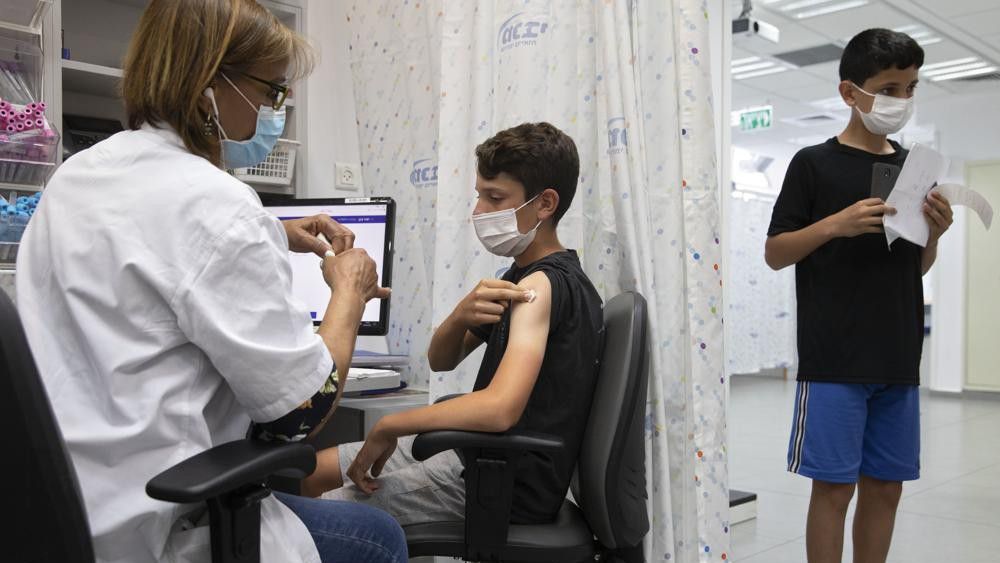 A child receives a dose of the Pfizer-BioNTech COVID-19 vaccine. (AP Photo/Sebastian Scheiner)