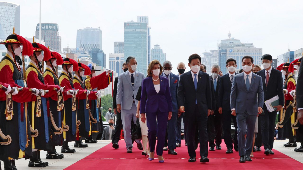 U.S. House Speaker Nancy Pelosi, front, center left, and South Korean National Assembly Speaker Kim Jin Pyo, center right, inspect an honor guard upon her arrival Thursday at the National Assembly in Seoul, South Korea. (Lee Jung-hoon/Yonhap via AP)
