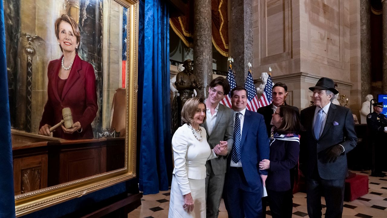 Speaker of the House Nancy Pelosi, D-Calif., is joined by her family and husband Paul Pelosi, far right, as they attend her portrait unveiling ceremony in Statuary Hall at the Capitol in Washington, Wednesday, Dec. 14, 2022. (AP Photo/J. Scott Applewhite)
