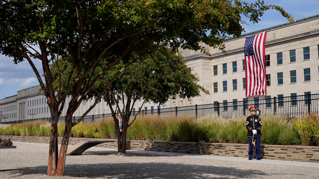 A U.S. Army band bugler stands ready on the National 9/11 Pentagon Memorial site for a ceremony to honor the lives lost at the Pentagon and onboard American Airlines Flight 77. (AP Photo/Alex Brandon)