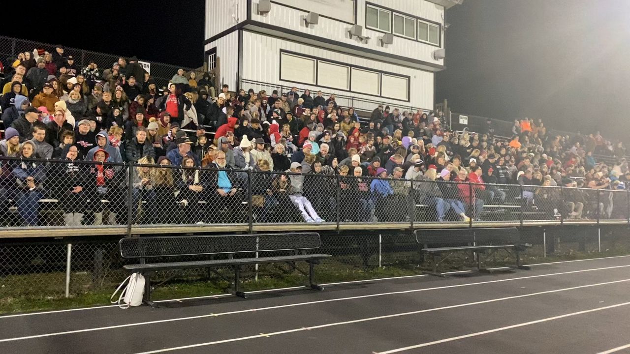 People gather in bleachers for Tuscarawas Valley Schools vigil following a fatal crash that left three students dead. (Spectrum News 1/Chloe McGill)